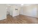 Spacious main bedroom features wood-look floors, ceiling fan, and en-suite bathroom at 9541 Sw 93Rd Loop, Ocala, FL 34481