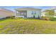 Lush green backyard featuring a screened-in patio, healthy lawn, and mature landscaping at 9697 Sw 102Nd Ter, Ocala, FL 34481