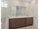 Beautiful bathroom featuring double sinks, stylish vanity, and a glass-enclosed shower for a luxurious feel at 9697 Sw 102Nd Ter, Ocala, FL 34481