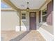 Inviting front porch with brick pavers, a hanging lantern, and charming shutters at 9697 Sw 102Nd Ter, Ocala, FL 34481