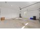 Spacious two-car garage with a concrete floor, white walls, and a window for natural light at 9697 Sw 102Nd Ter, Ocala, FL 34481