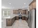 Stylish kitchen showcasing stainless steel appliances, granite countertops, and tile flooring at 9697 Sw 102Nd Ter, Ocala, FL 34481
