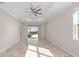 Bright living space with tile floor, ceiling fan, and sliding glass doors to the patio at 9697 Sw 102Nd Ter, Ocala, FL 34481