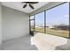 Relaxing screened patio with a view of green lawn and surrounding houses on a sunny day at 9697 Sw 102Nd Ter, Ocala, FL 34481