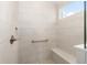 Modern tiled shower with a built-in bench, safety bar, and sleek fixtures offers a spa-like experience at 9697 Sw 102Nd Ter, Ocala, FL 34481