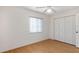 Bedroom with light wood floors, a ceiling fan, a window, and a closet at 10141 Sw 62Nd Terrace Rd, Ocala, FL 34476