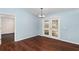 Bright dining room features wood floors and view to the backyard through charming French doors at 10141 Sw 62Nd Terrace Rd, Ocala, FL 34476