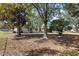 Well-maintained front yard with mature trees creating a peaceful and inviting curb appeal for the property at 10141 Sw 62Nd Terrace Rd, Ocala, FL 34476