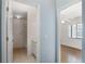 Hallway view towards a bathroom and a bedroom with hardwood floors at 10141 Sw 62Nd Terrace Rd, Ocala, FL 34476