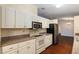 Kitchen boasts neutral countertops, stainless steel appliances and white cabinetry at 10141 Sw 62Nd Terrace Rd, Ocala, FL 34476