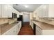 Functional kitchen features stainless appliances, plenty of counter space, and sleek white cabinets at 10141 Sw 62Nd Terrace Rd, Ocala, FL 34476