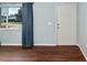 A view of the living room with hardwood floor, a window, and a door at 10141 Sw 62Nd Terrace Rd, Ocala, FL 34476