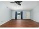 Empty living room featuring hardwood floors, a large window, and a ceiling fan at 10141 Sw 62Nd Terrace Rd, Ocala, FL 34476