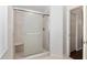 Shower room with a frosted glass door, stone-look tile, and a built-in seat at 10141 Sw 62Nd Terrace Rd, Ocala, FL 34476