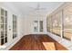 Inviting sunroom features hardwood flooring and sliding doors leading to the outdoors at 10141 Sw 62Nd Terrace Rd, Ocala, FL 34476