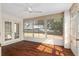 Bright sunroom with wood flooring and ceiling fan offering a comfortable space at 10141 Sw 62Nd Terrace Rd, Ocala, FL 34476