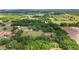 Expansive aerial view captures the property surrounded by mature trees, showcasing its vast land and privacy at 10575 Sw 27Th Ave, Ocala, FL 34476