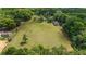 Expansive aerial view showcasing the home, large grassy yard, and lush surrounding trees, highlighting the property's serene setting at 10575 Sw 27Th Ave, Ocala, FL 34476