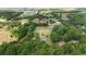 Aerial view of a large property surrounded by lush trees and farmland at 10575 Sw 27Th Ave, Ocala, FL 34476