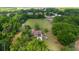 An aerial view of an estate with a pool and surrounding green space at 10575 Sw 27Th Ave, Ocala, FL 34476