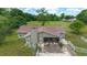 Back exterior of home has a covered screened-in porch, chimney, and a fenced yard with mature trees at 10575 Sw 27Th Ave, Ocala, FL 34476