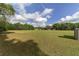 Vast backyard with lush green grass, surrounded by mature trees at 10575 Sw 27Th Ave, Ocala, FL 34476