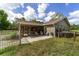 Backyard featuring a screened-in porch, fenced yard and lush vegetation at 10575 Sw 27Th Ave, Ocala, FL 34476