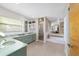 Spacious bathroom featuring tiled floors, dual sink vanity, shower, and separate bathtub, providing a relaxing retreat at 10575 Sw 27Th Ave, Ocala, FL 34476