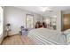 Cozy bedroom features wood floors, light walls and a mirrored closet at 10575 Sw 27Th Ave, Ocala, FL 34476