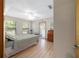 Cozy bedroom with natural light, wood laminate flooring, and neutral color palette at 10575 Sw 27Th Ave, Ocala, FL 34476