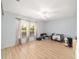 Bright bedroom with light wood floors, ceiling fan, and a window view at 10575 Sw 27Th Ave, Ocala, FL 34476