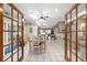 Open dining room with skylights, ceiling fans, tile flooring, and view to living spaces at 10575 Sw 27Th Ave, Ocala, FL 34476