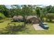 Aerial view showcases the home with a large, well-maintained front yard, mature trees, and ample parking at 10575 Sw 27Th Ave, Ocala, FL 34476