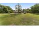 The house sits on a large grassy lot, showcasing its rural charm with lots of shade and open space at 10575 Sw 27Th Ave, Ocala, FL 34476