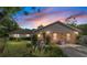 Inviting home exterior featuring stone accents, landscaping, and a well-lit walkway to the front door at 10575 Sw 27Th Ave, Ocala, FL 34476