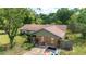 Aerial view of a home exterior with stone accents, a large yard, and a blue truck in the driveway at 10575 Sw 27Th Ave, Ocala, FL 34476