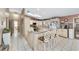 Bright eat-in kitchen features granite countertops, ample cabinetry, tile flooring, and a breakfast bar at 10575 Sw 27Th Ave, Ocala, FL 34476