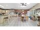 Bright and spacious kitchen with granite countertops, tile floors, and an adjacent dining area at 10575 Sw 27Th Ave, Ocala, FL 34476