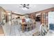 Bright eat-in kitchen with an island, white cabinetry, and a ceiling fan at 10575 Sw 27Th Ave, Ocala, FL 34476