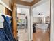 Hall view of laundry area with appliances, wood door with a view to the living room at 10575 Sw 27Th Ave, Ocala, FL 34476