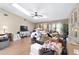 Living room with vaulted ceiling, skylight, and laminate wood flooring at 10575 Sw 27Th Ave, Ocala, FL 34476