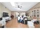 Bright living room with hardwood floors, ceiling fan, and natural light, currently staged with boxes and furniture at 10575 Sw 27Th Ave, Ocala, FL 34476