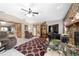 Cozy living room with stone fireplace, ceiling fan, and access to dining area at 10575 Sw 27Th Ave, Ocala, FL 34476