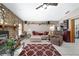 Cozy living room with stone fireplace, tile flooring, and comfortable seating at 10575 Sw 27Th Ave, Ocala, FL 34476