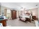 Spacious main bedroom featuring a large bed, carpet floors and a ceiling fan at 10575 Sw 27Th Ave, Ocala, FL 34476