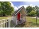 Exterior view of a small, fenced outbuilding on a grassy lawn at 10575 Sw 27Th Ave, Ocala, FL 34476