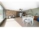 Enclosed porch features stone accent wall, dining area, and outdoor kitchen at 10575 Sw 27Th Ave, Ocala, FL 34476