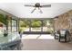 Relaxing sunroom with tile flooring, stone accent wall, and views of the backyard pool at 10575 Sw 27Th Ave, Ocala, FL 34476