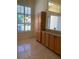 Eat-in kitchen with breakfast bar, light colored cabinets, and tile floors at 10918 Sw 71St Cir, Ocala, FL 34476