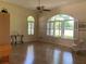 Spacious living room with a ceiling fan and large windows with plantation shutters allowing for plenty of natural light at 10918 Sw 71St Cir, Ocala, FL 34476